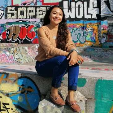 Karen Garcia-Rodriquez sitting on a wall.